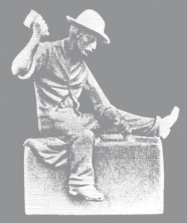 A statue of a man sitting on a box holding a hammer