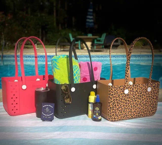 display of tote bags next to pool