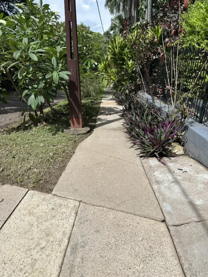 Straight Stone Walkway Flanked by a Green Bush — I Do It All in Caloundra, QLD