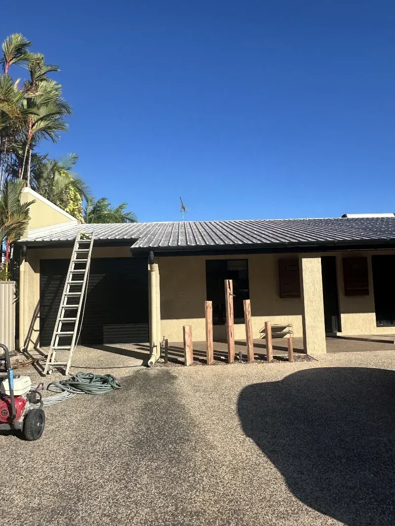 A Ladder Leans Against a Light-Colored House with A Tiled Roof — I Do It All in Caloundra, QLD