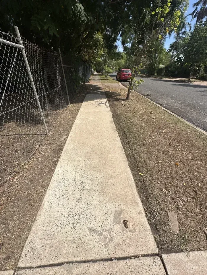 Concrete Sidewalk Runs Along a Chain-link Fence — I Do It All in Caloundra, QLD