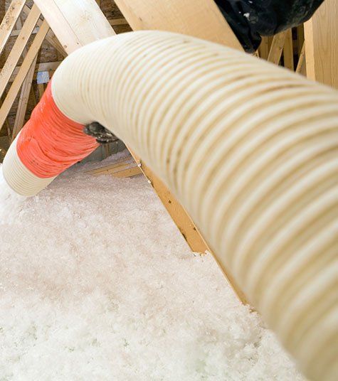 Worker Spraying Blown Fiberglass Insulation — Derby, KS — Dennis Insulation