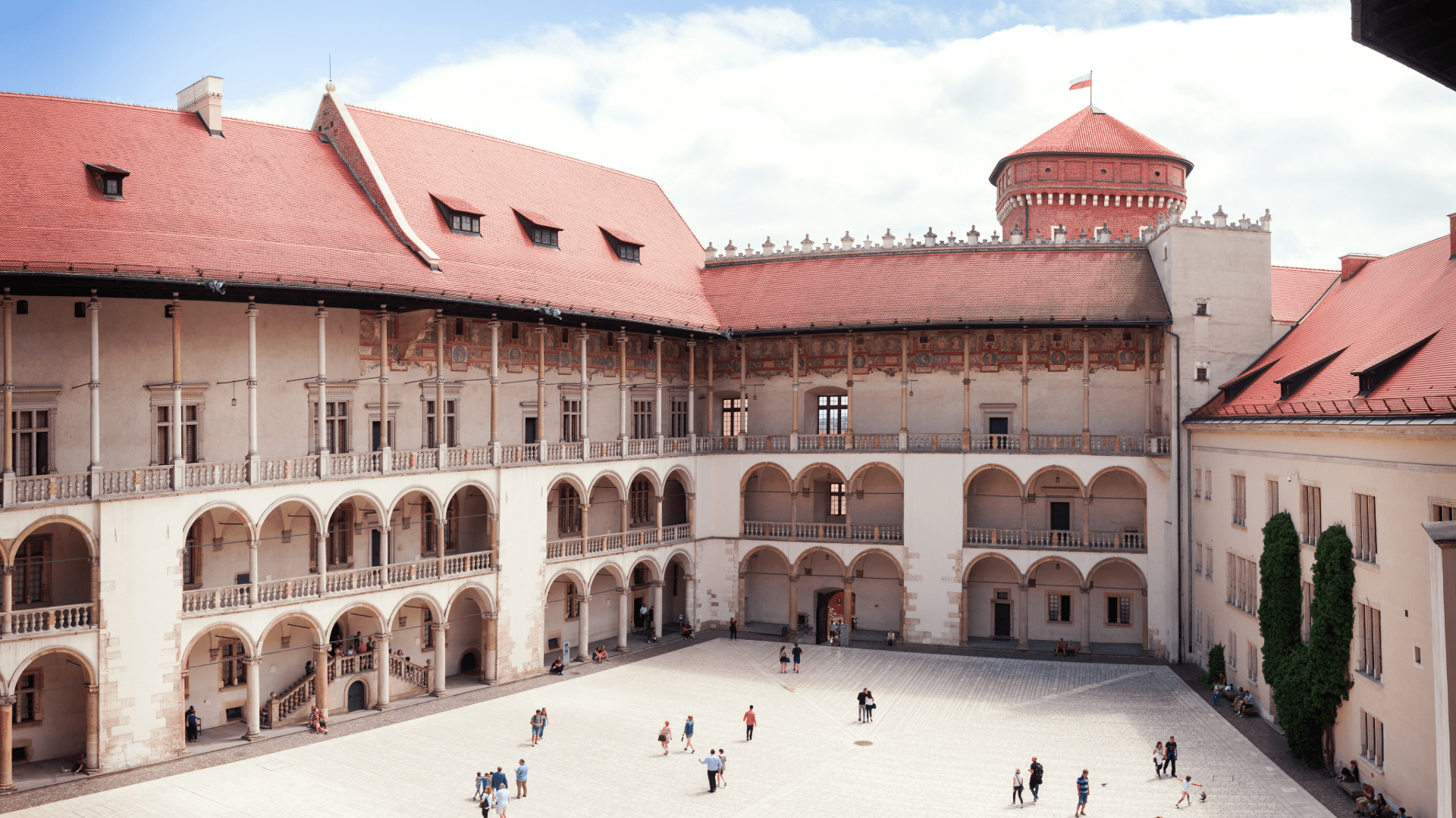 Inner courtyard of Wawel Castle in Kraków with historic architecture and people walking