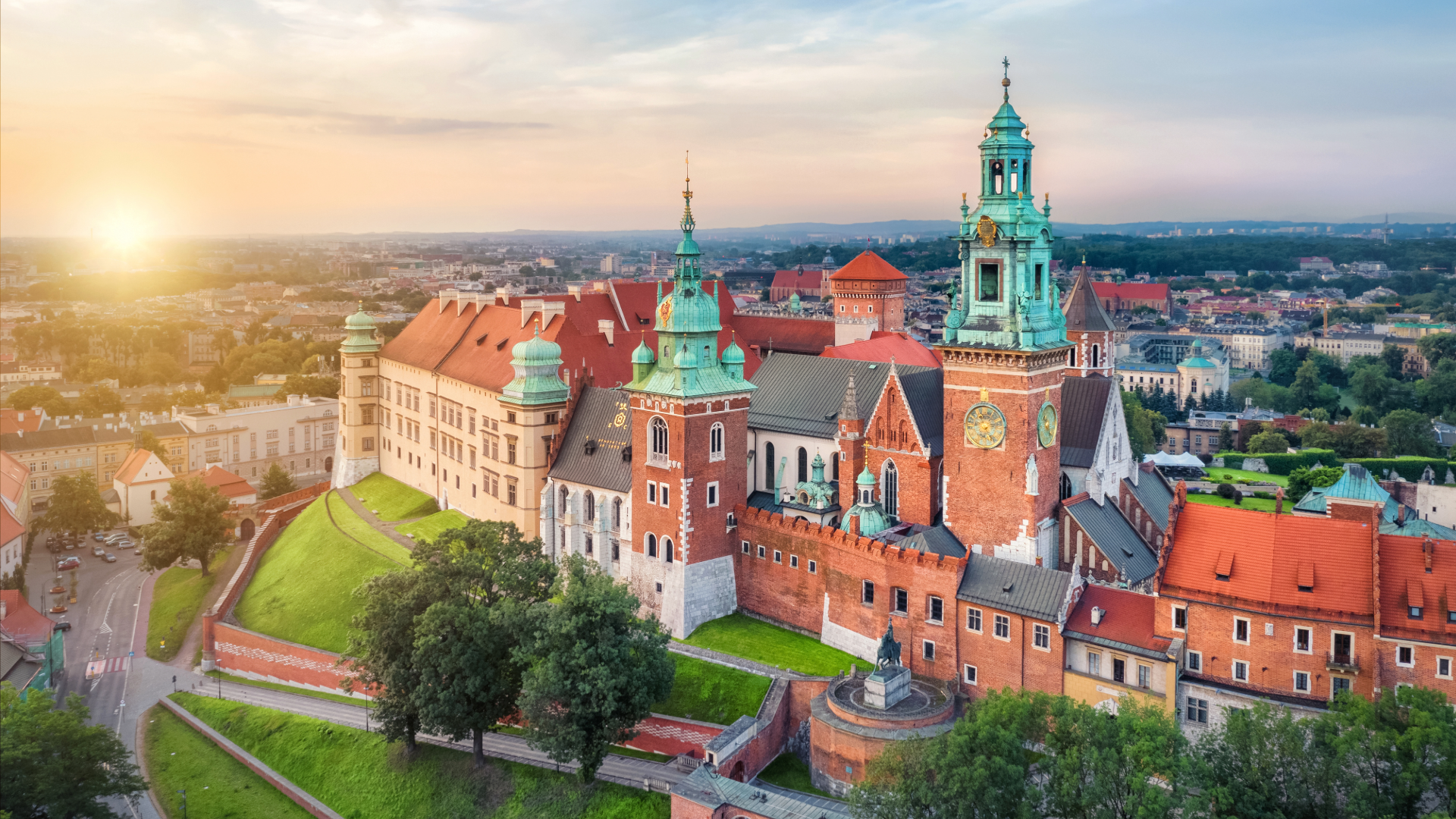 Aerial view of the Vistula River and bridges in Krakow at sunset.