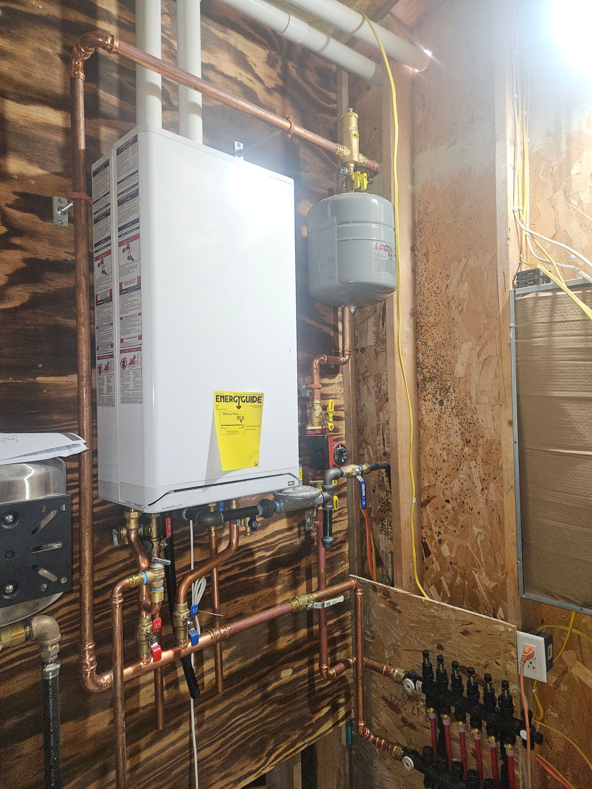 A basement with a furnace and a box on the floor.