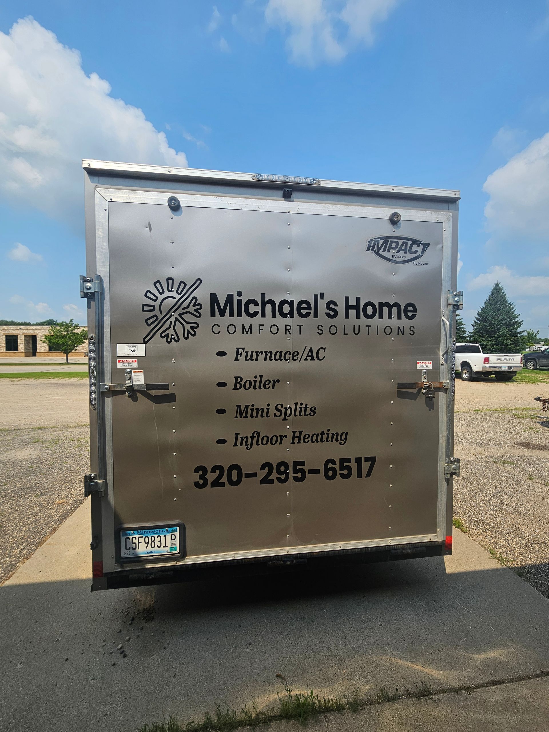 The back of a trailer for michael 's home is parked on the side of the road.