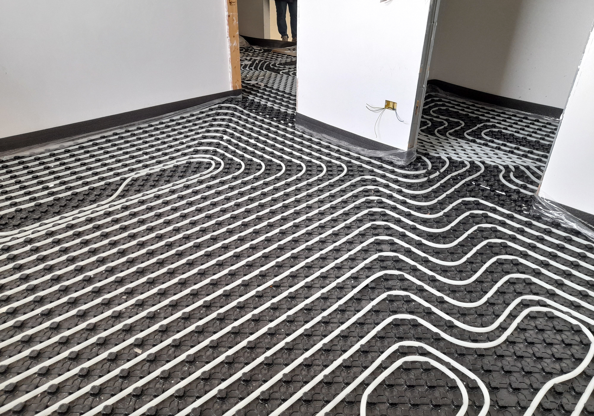 A room with a heating system on the floor.