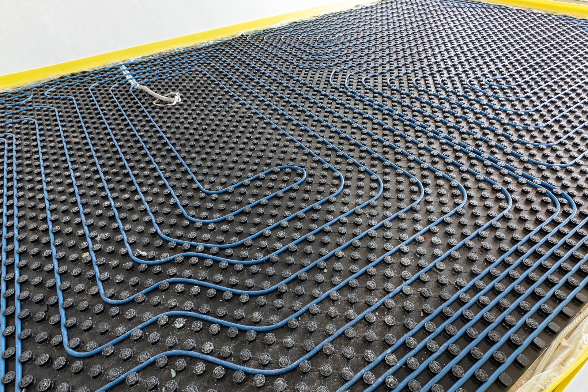 A close up of a underfloor heating system on a floor.