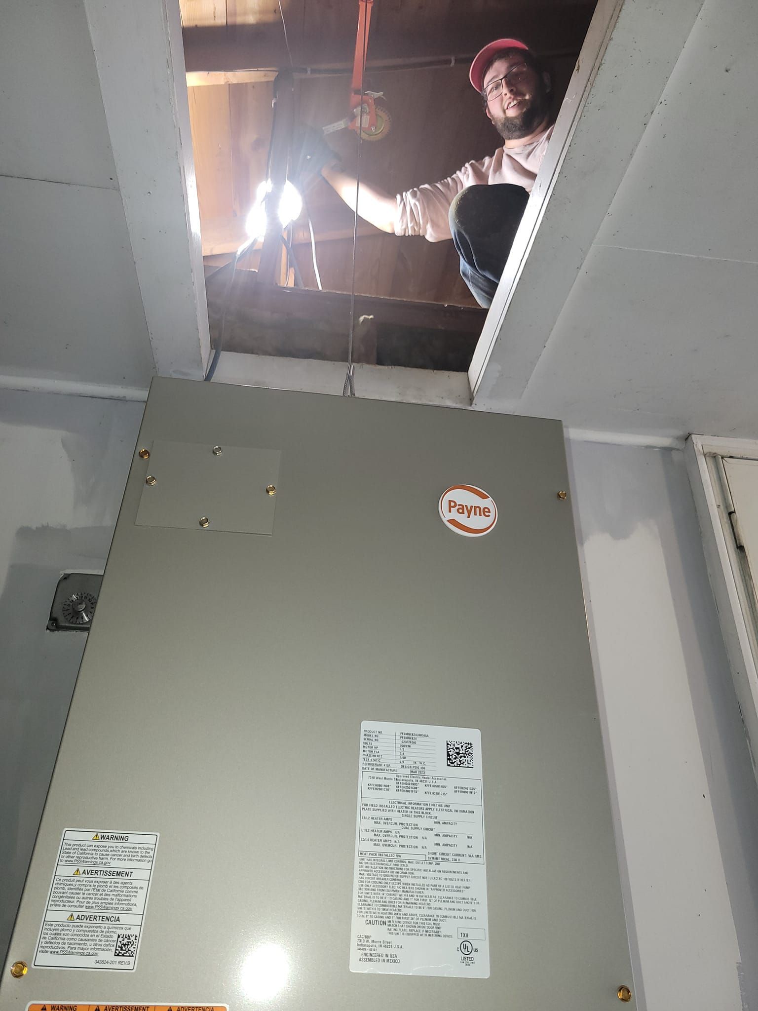 A man is looking up into the ceiling of a building.