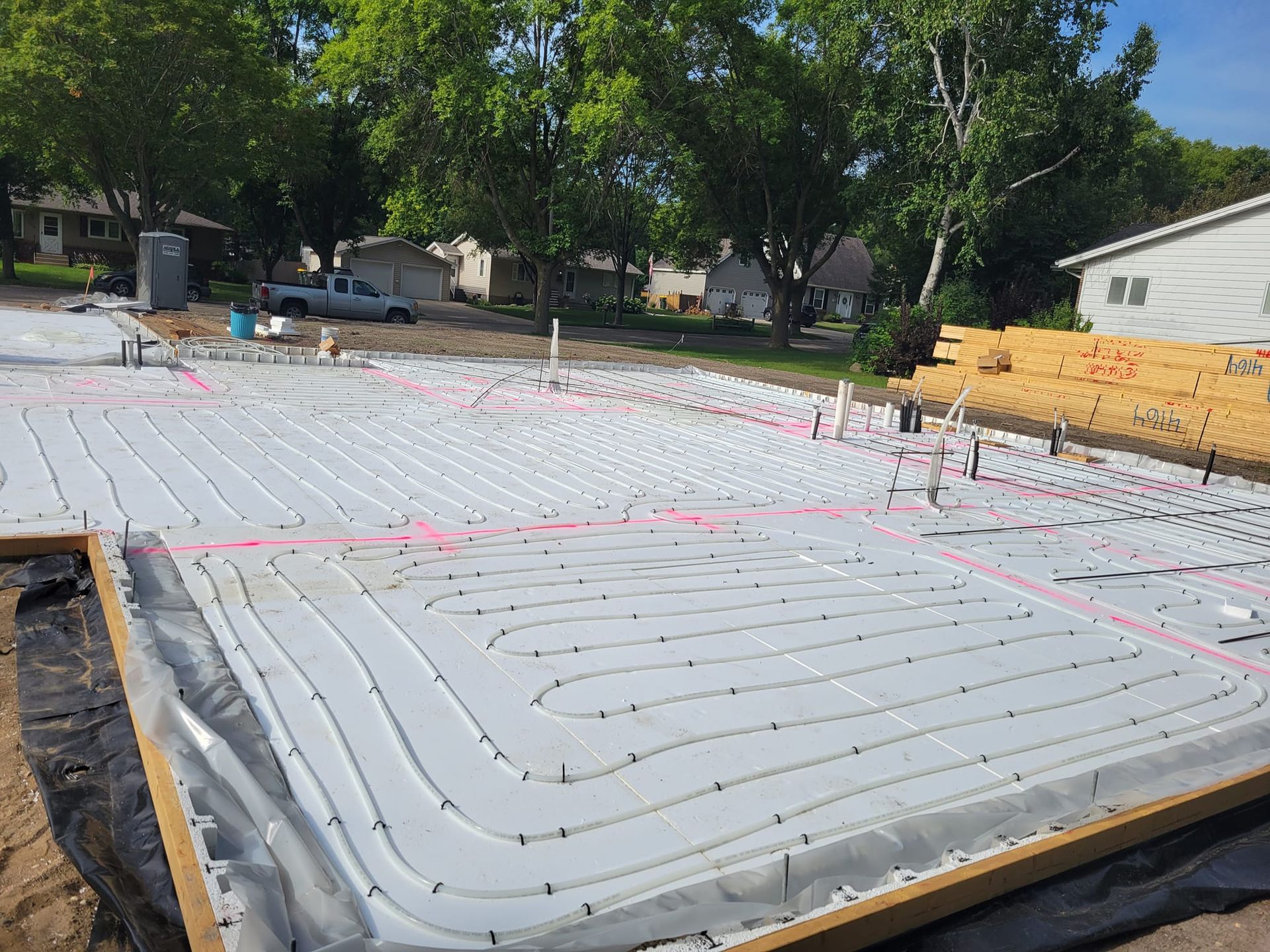 The foundation of a house is being built and has a lot of lines on it.
