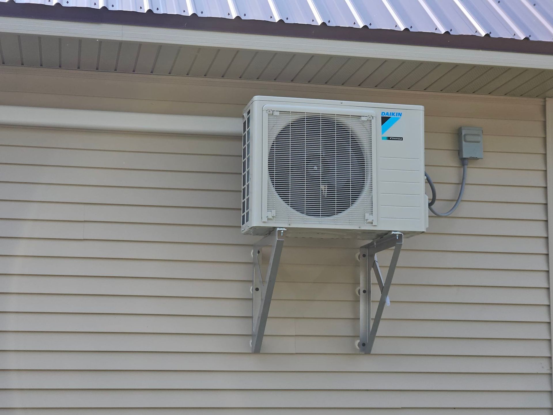 A daikin air conditioner is mounted on the side of a house