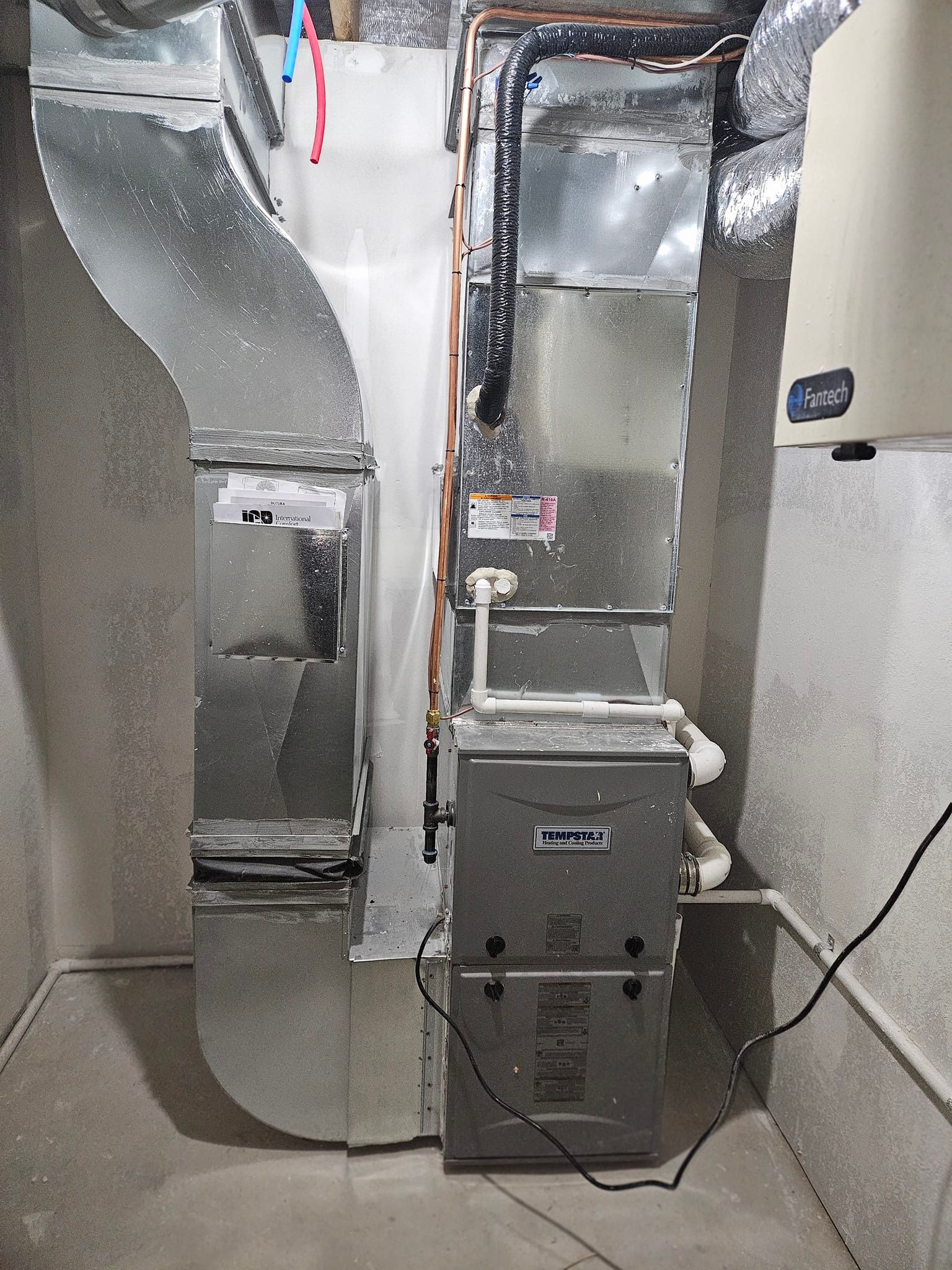 A picture of a heating and cooling system in a basement.
