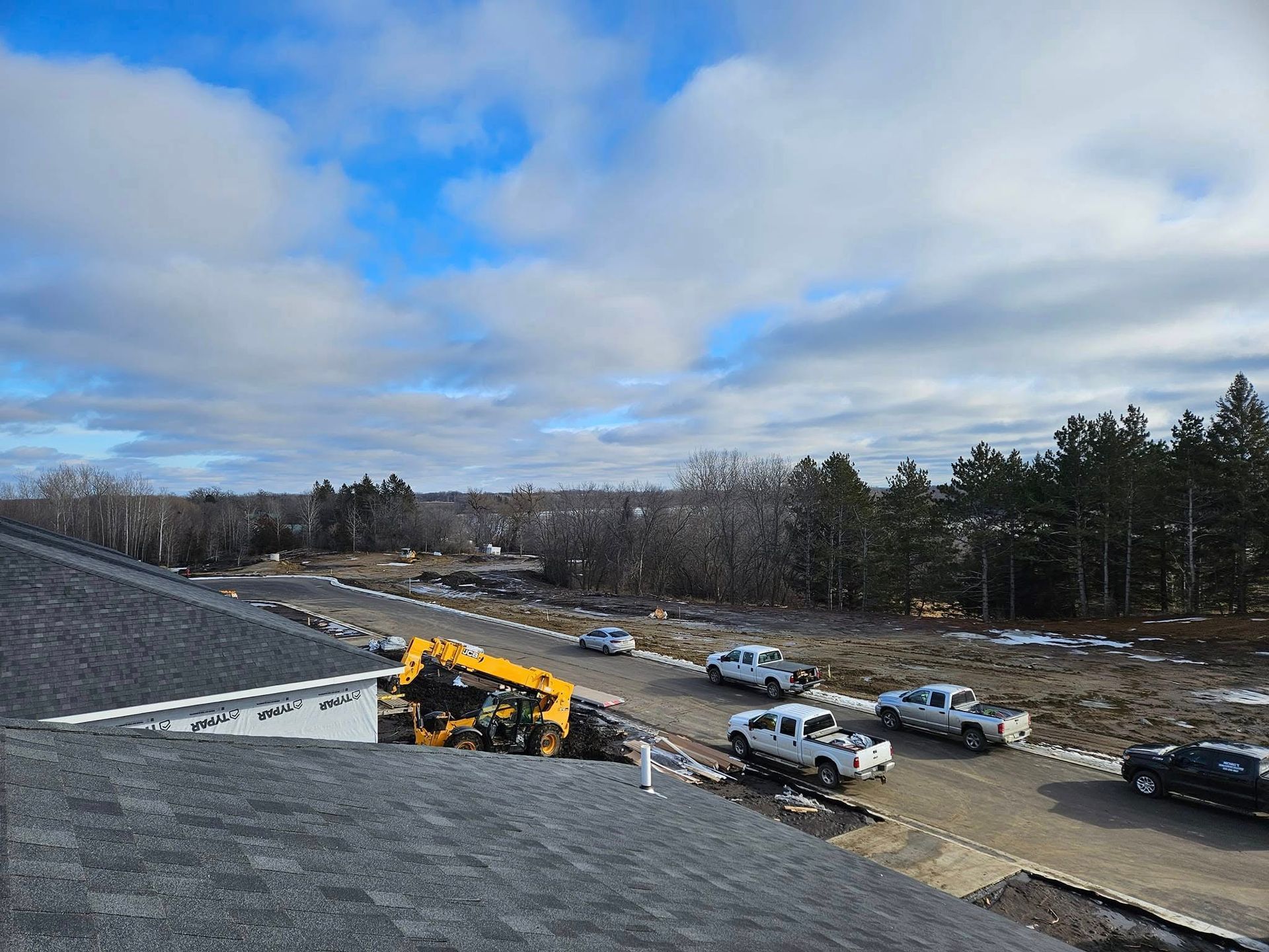A group of trucks are parked on the side of a road.