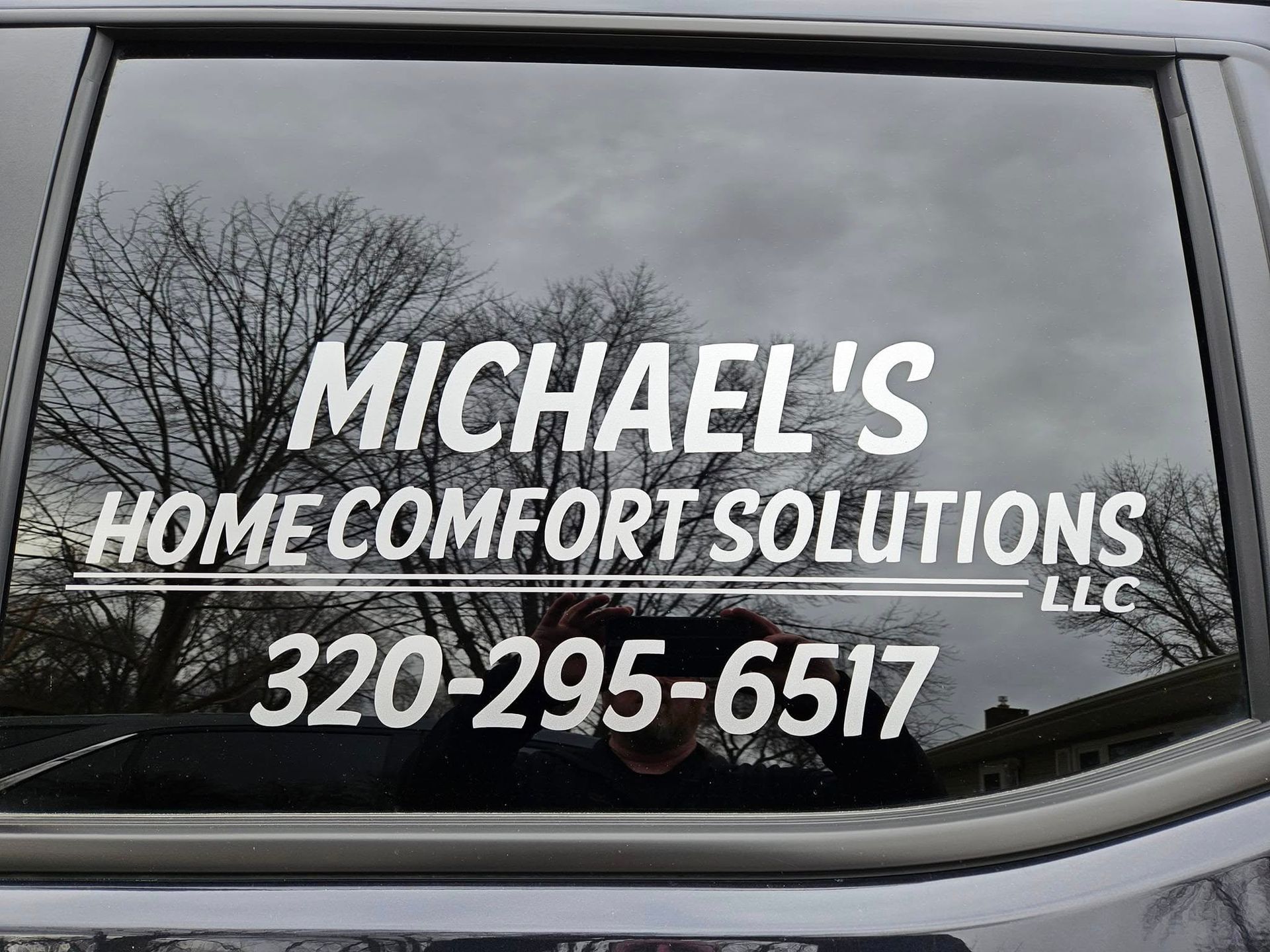 A car window with a sticker on it that says michael 's home comfort solutions