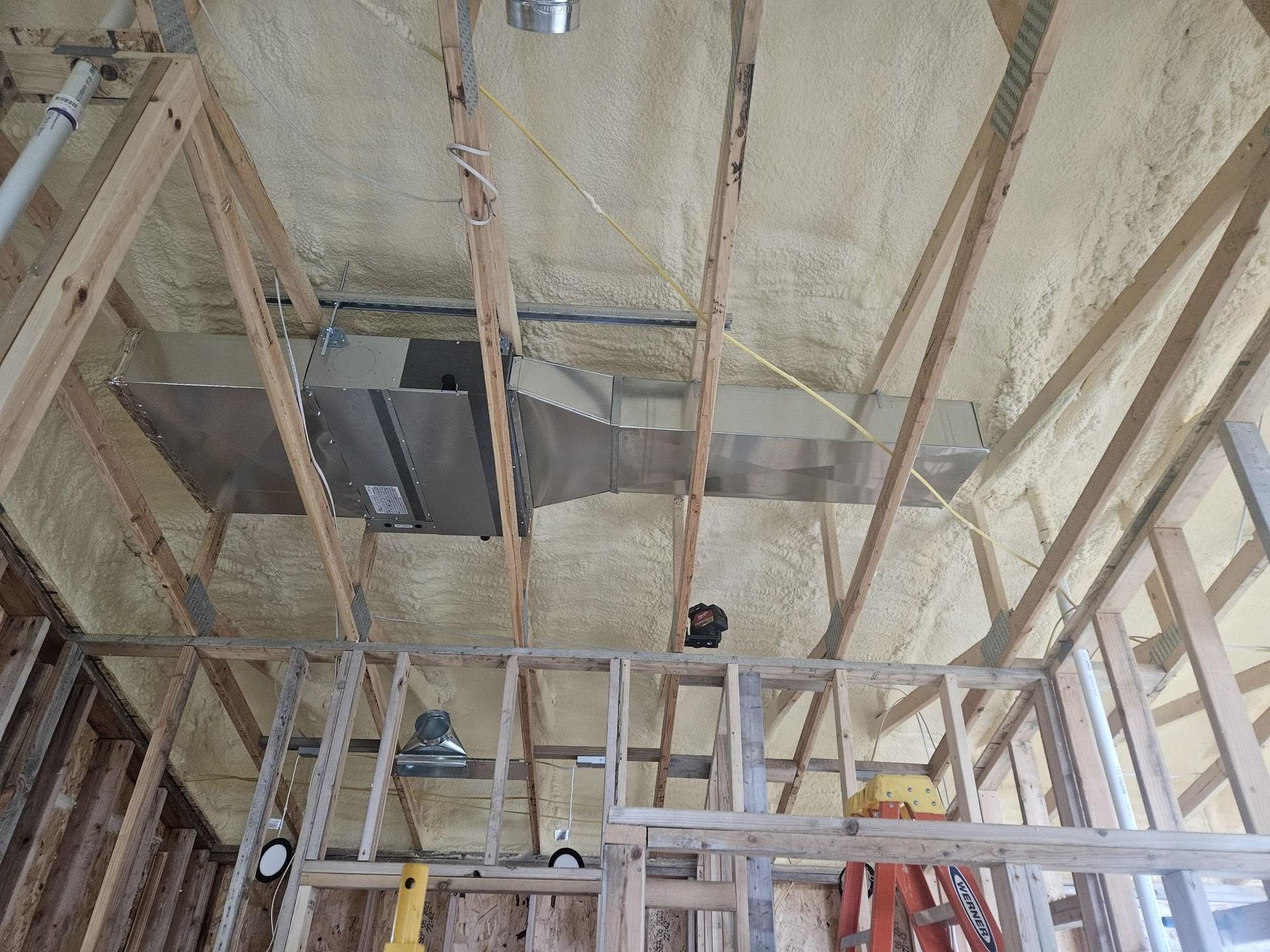 A room with a ceiling that is covered in foam and a ladder.