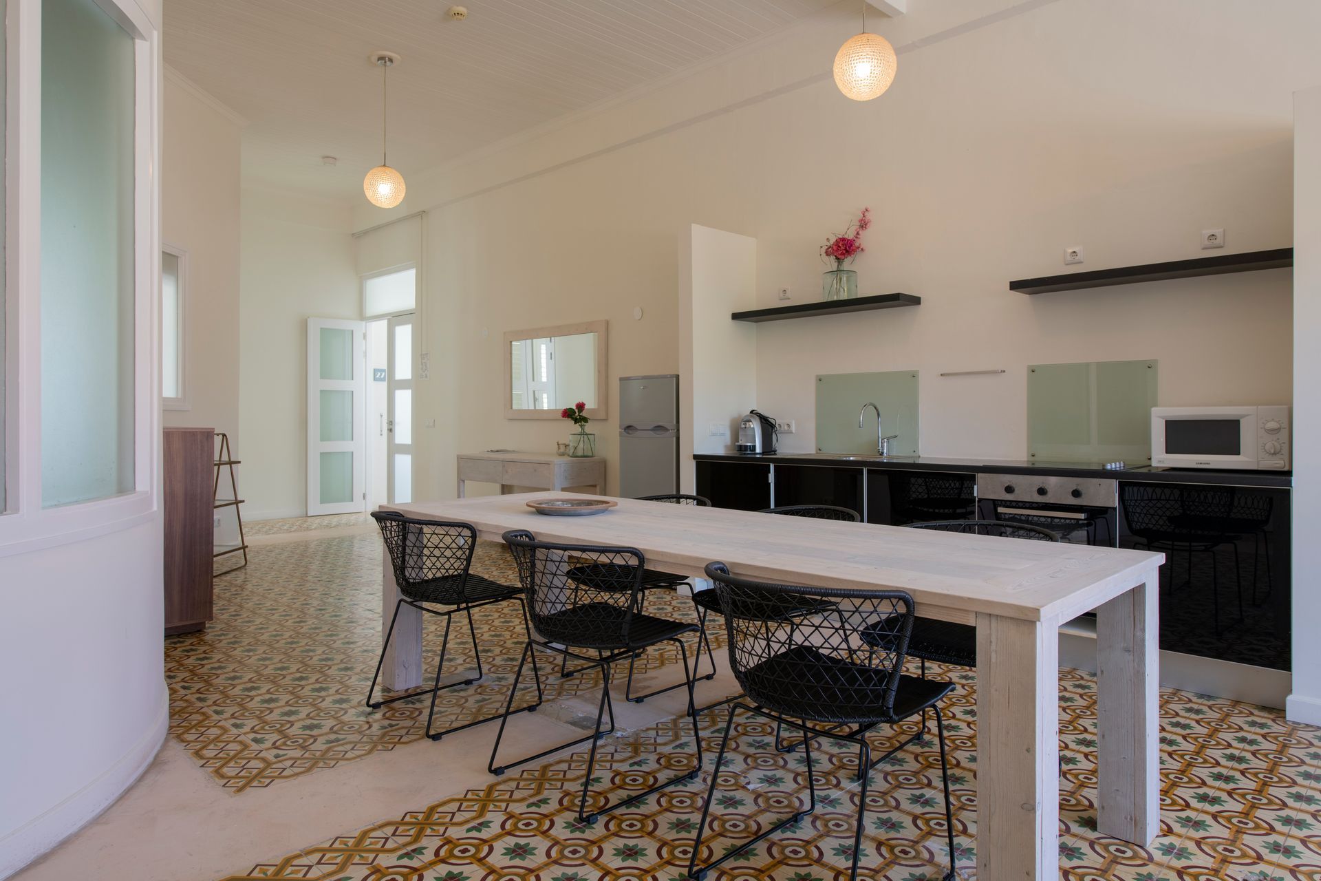 A kitchen with a long table and chairs in it t Klooster Hotel Curacao