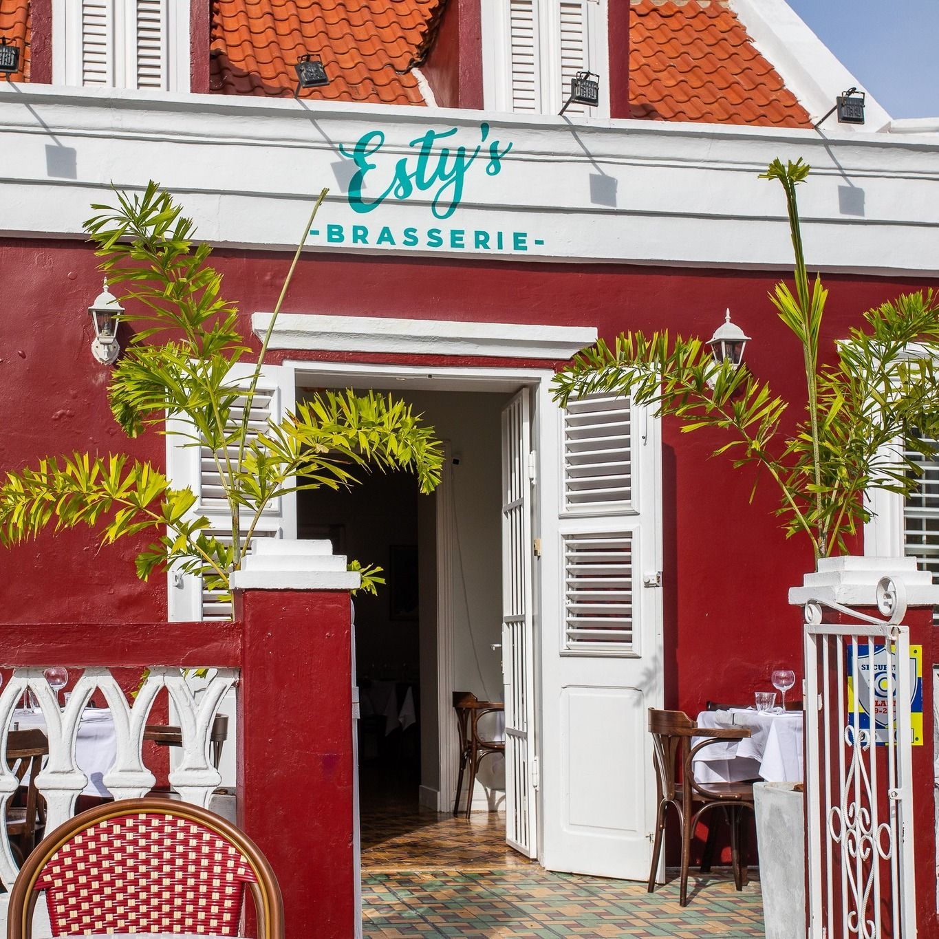 A red building with a sign that says esty 's brasserie