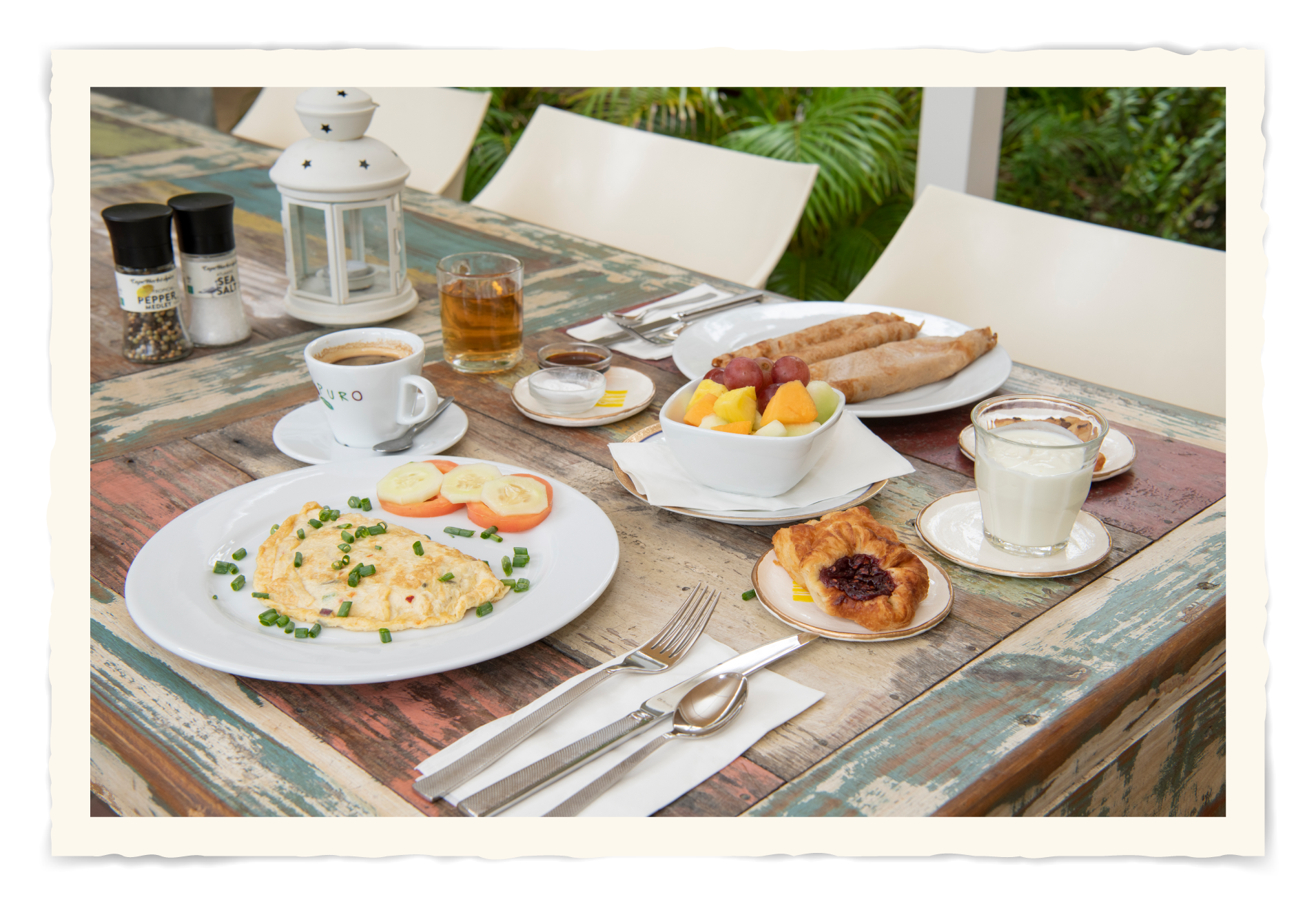 A table topped with plates of food and drinks.t Klooster Hotel Curacao