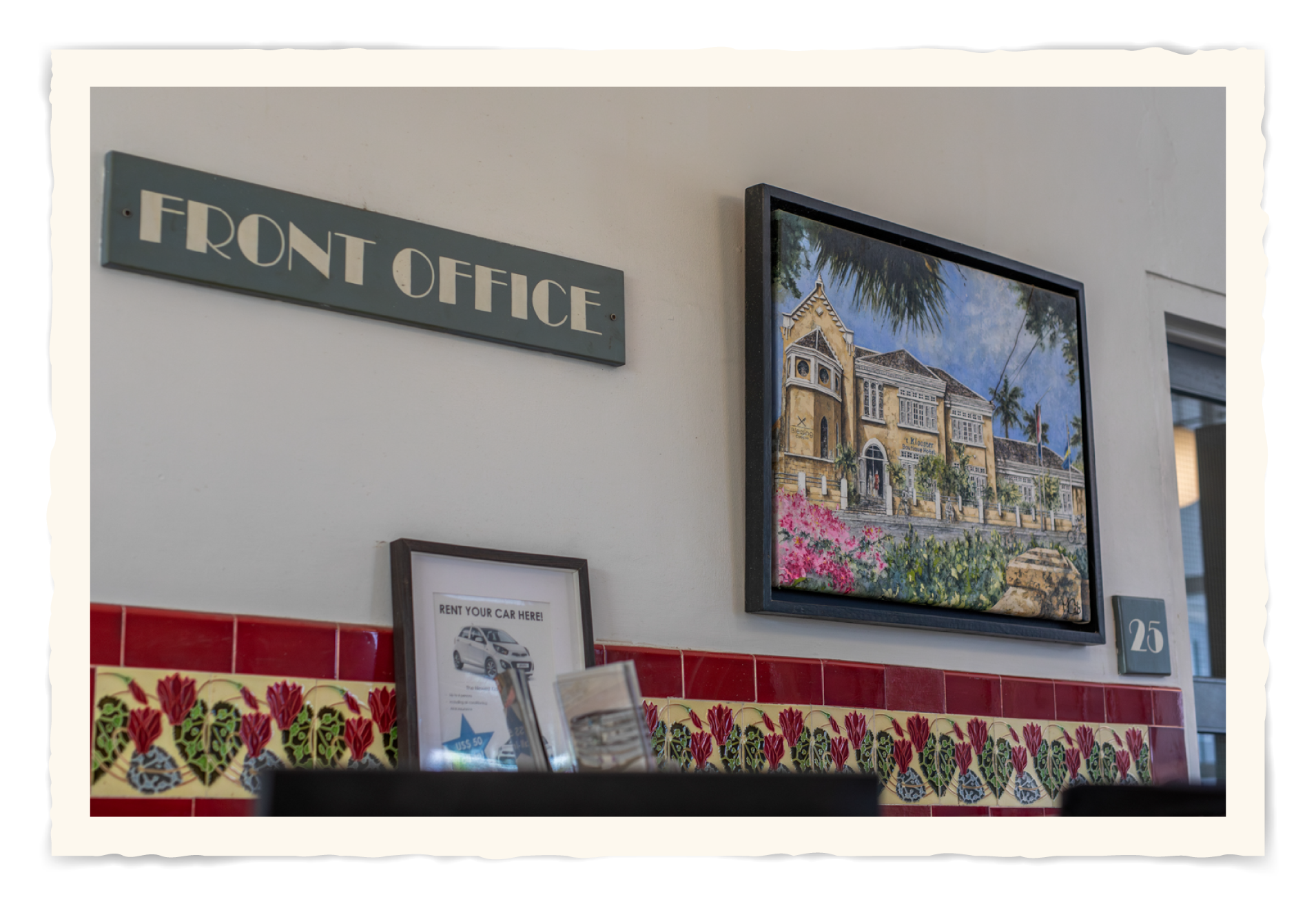 There is a sign on the wall that says front office. t Klooster Hotel Curacao