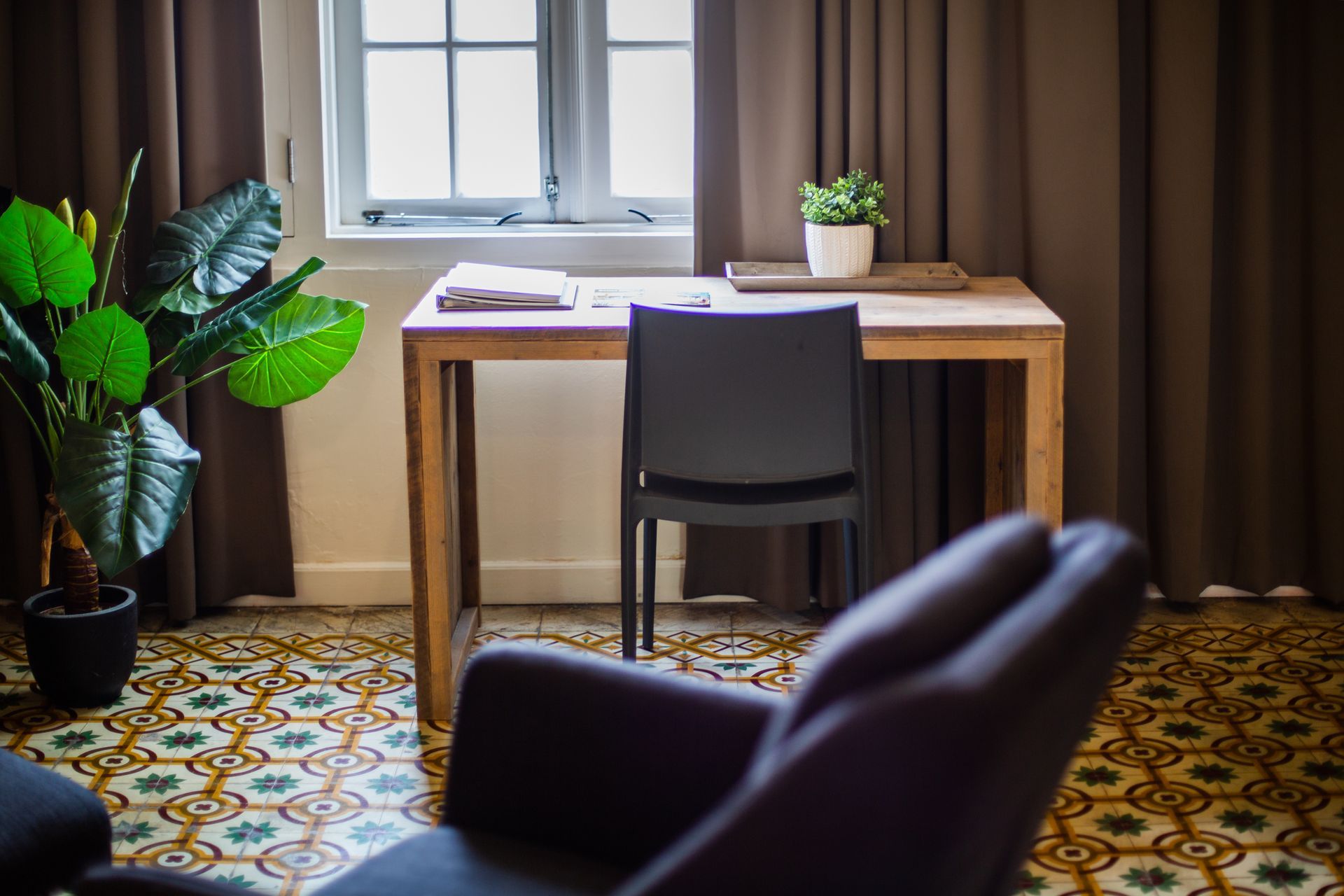 There is a chair and a desk in the room.