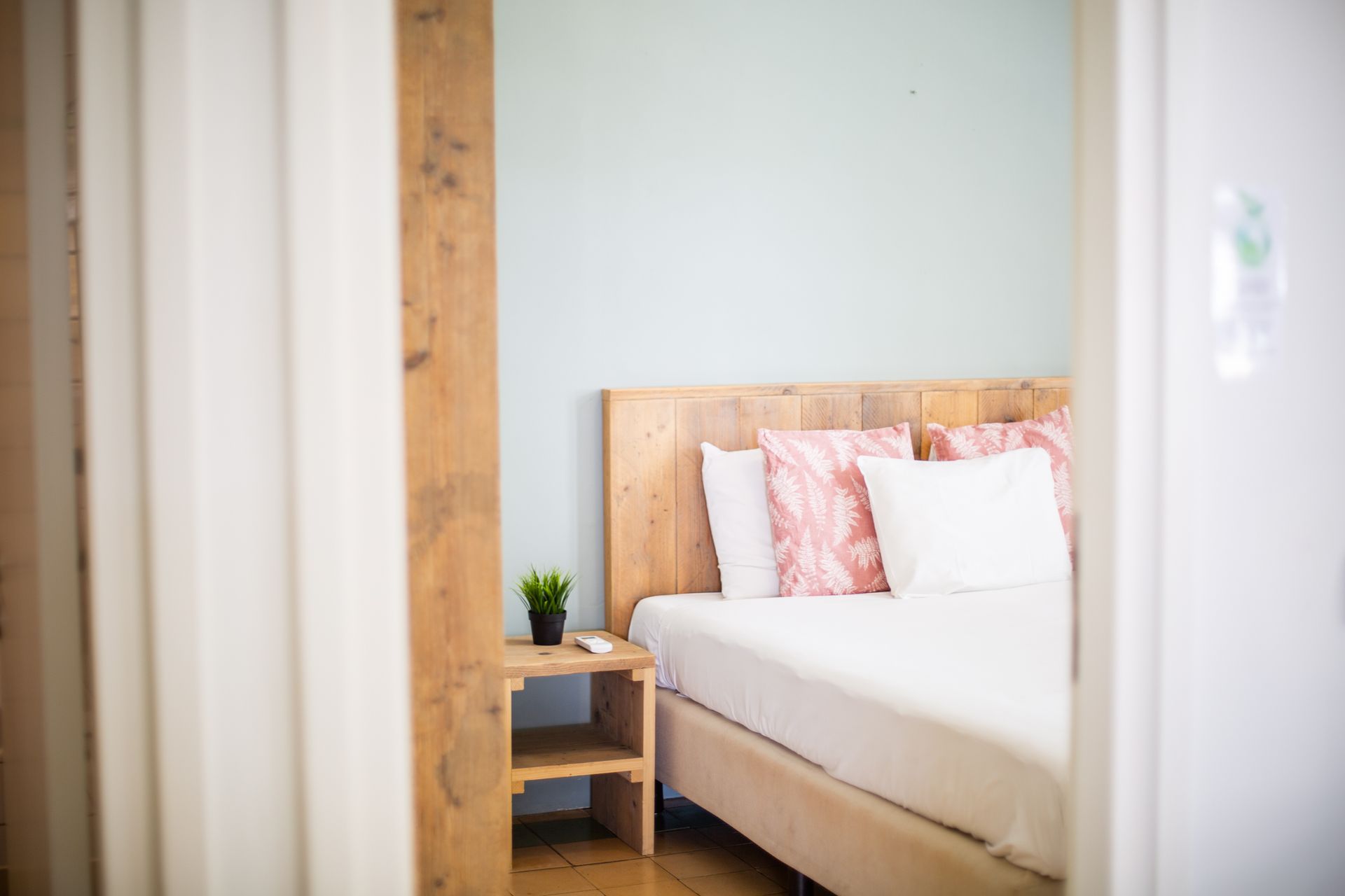 A bedroom with a bed and a nightstand in it.