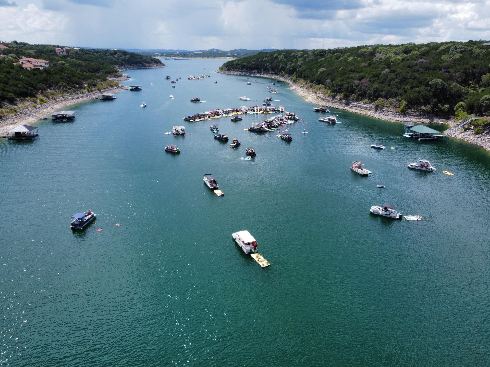 A blue tarp is covering a boat in the snow