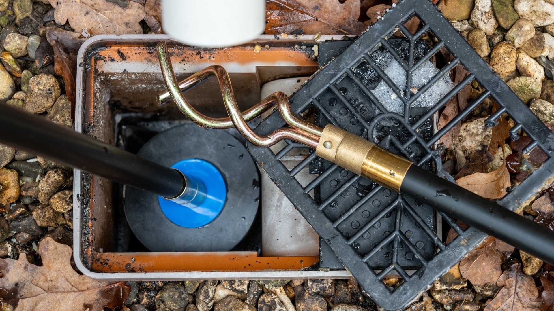 A drain cleaner is being used to clean a drain.