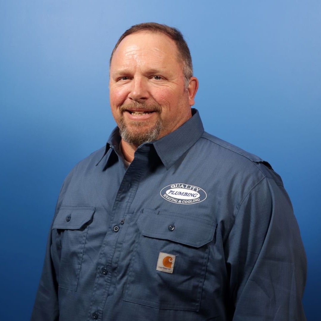 A man wearing a blue shirt with a carhartt logo on it