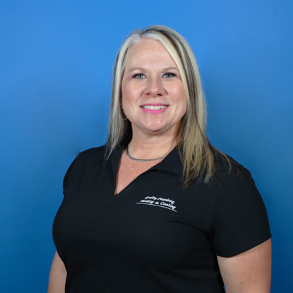 The woman is wearing a black shirt and smiling for the camera.