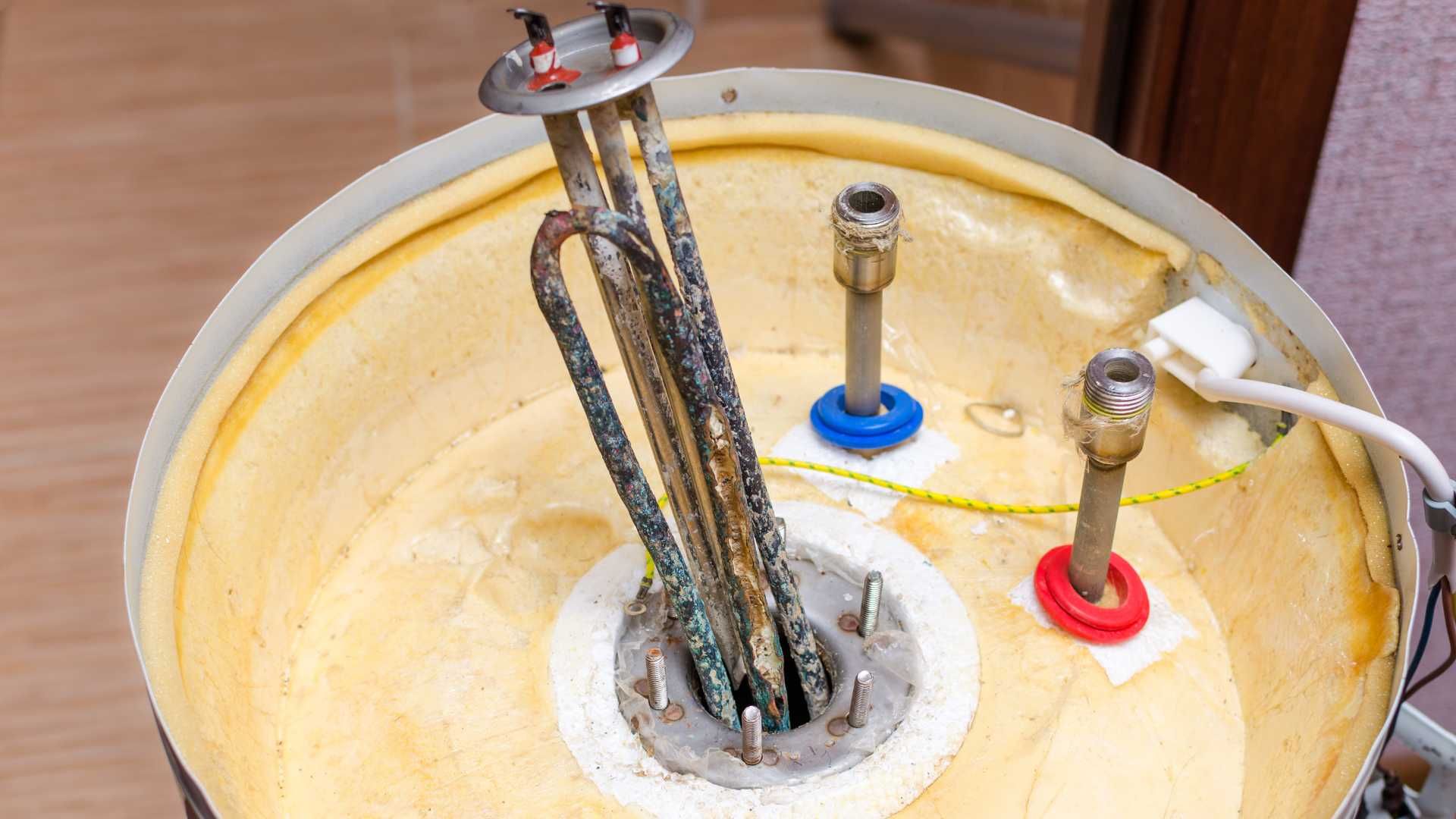 A close up of a water heater with a bunch of wires coming out of it.