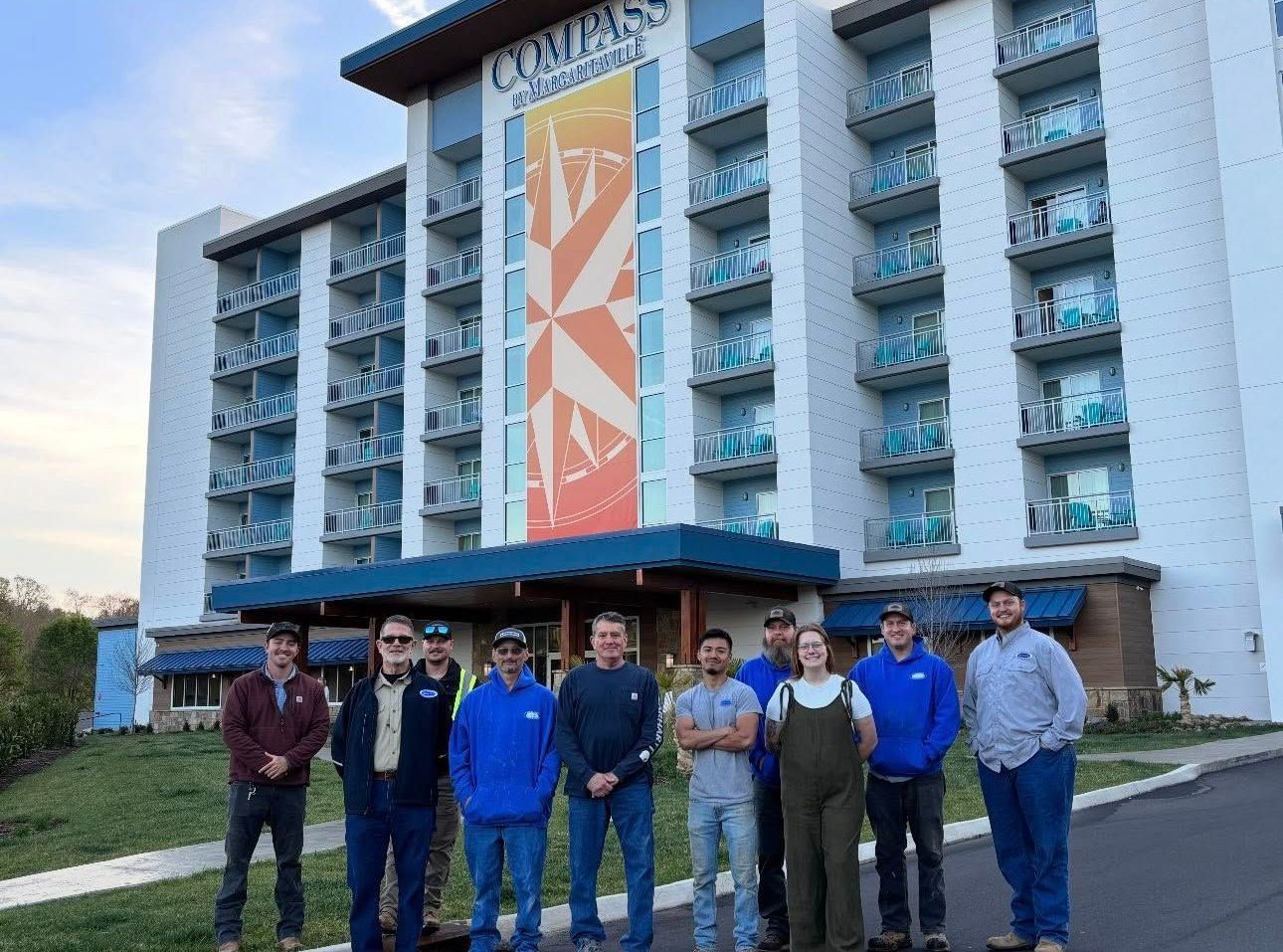 A group of people are standing in front of a large building.