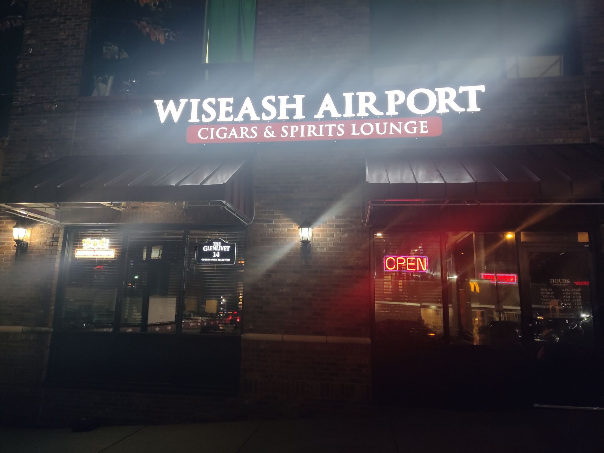 Wiseash airport cigars and spirits lounge is lit up at night