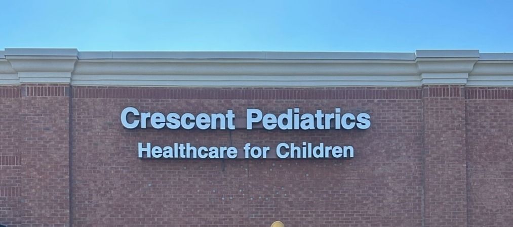 A sign on the side of a building that says crescent pediatrics healthcare for children