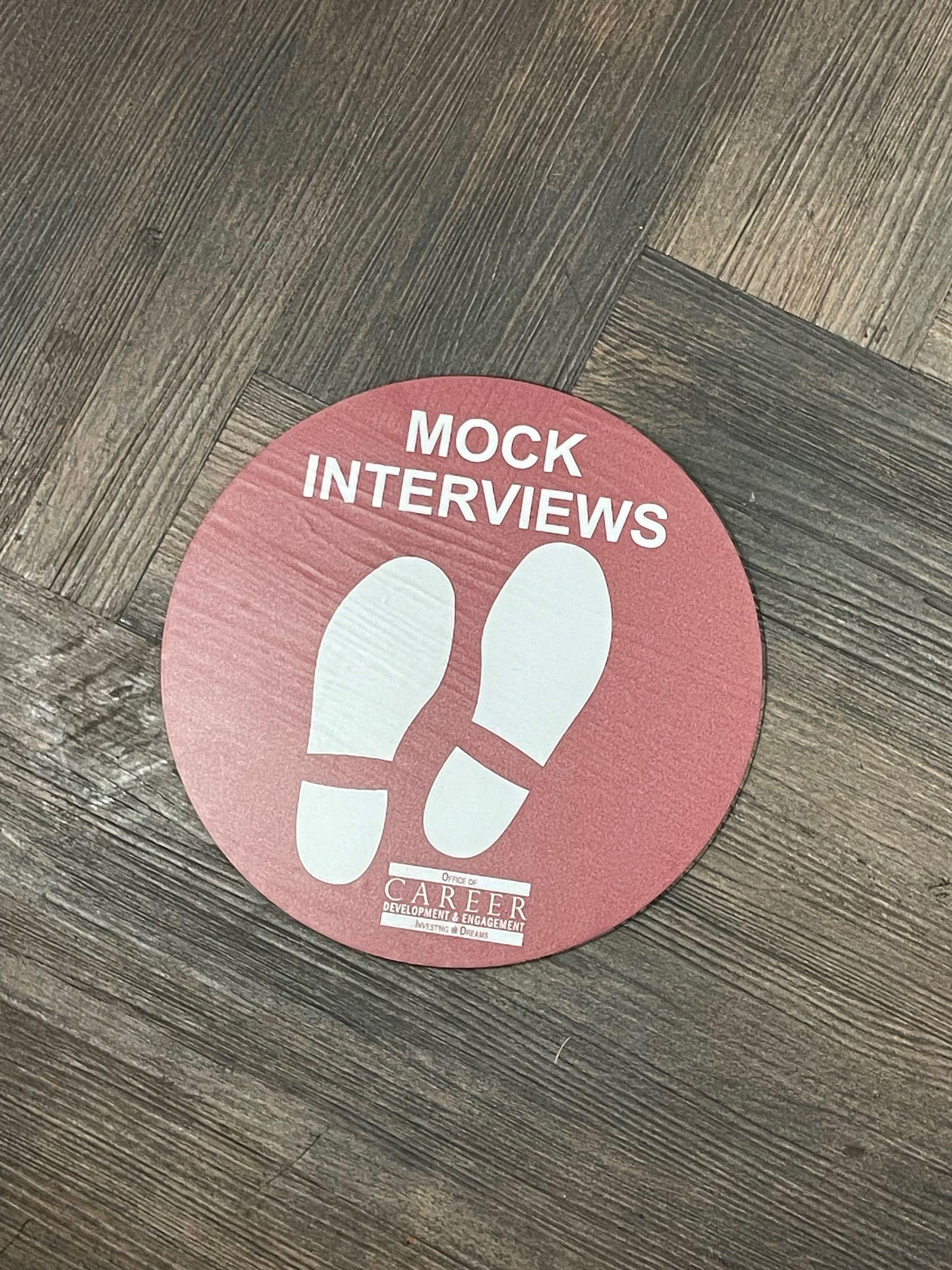 A red circle with white footprints on it that says `` mock interviews ''.
