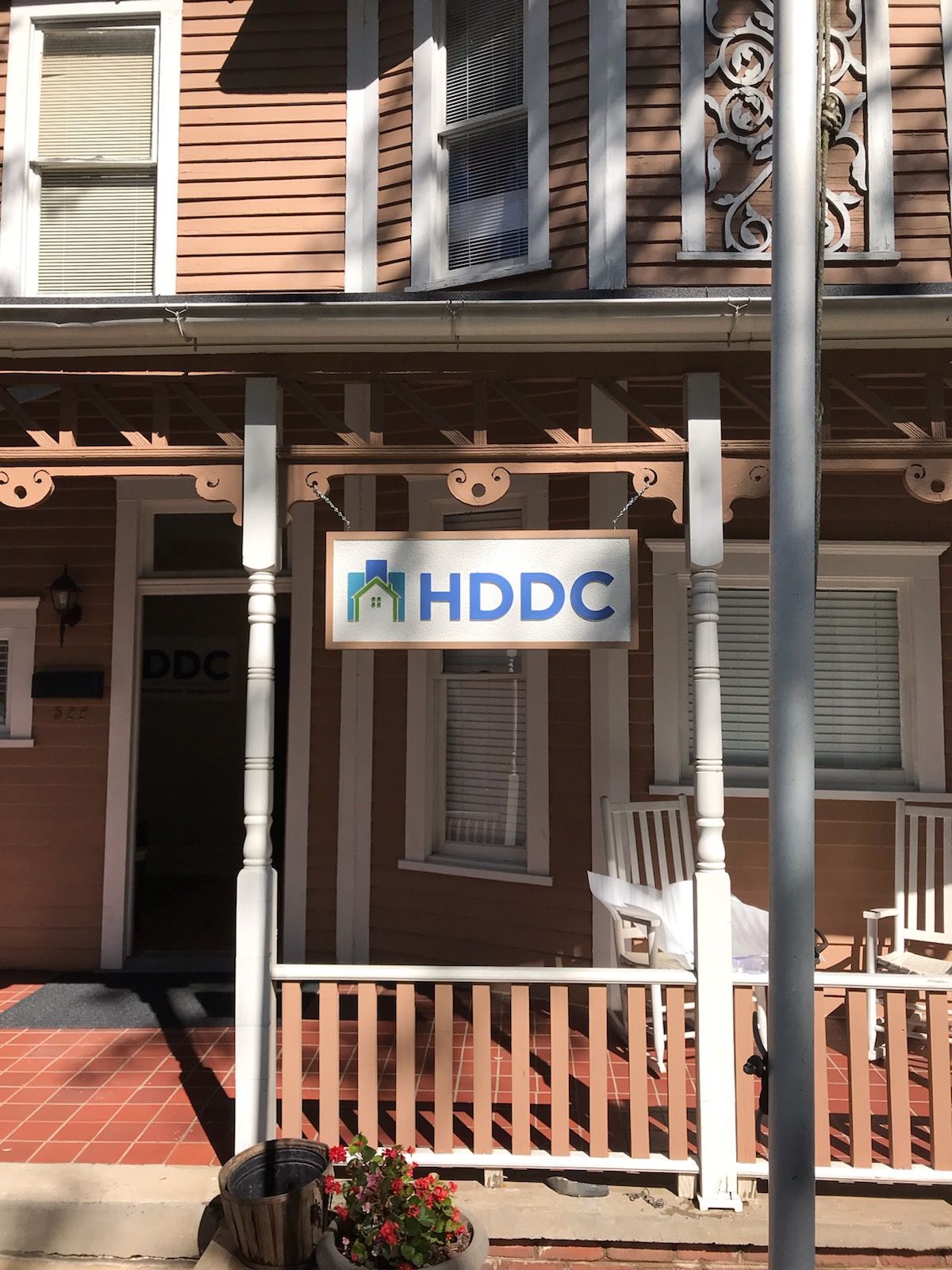 A house with a porch and a sign that says hddc