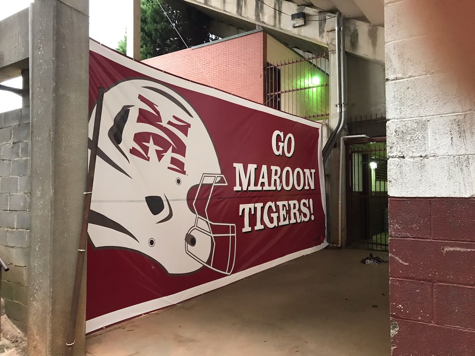 A maroon and white sign that says go maroon tigers