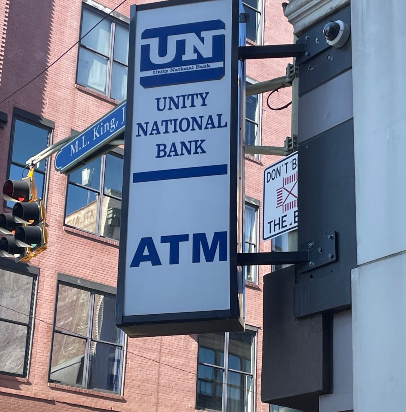 A sign that says unity national bank atm on it