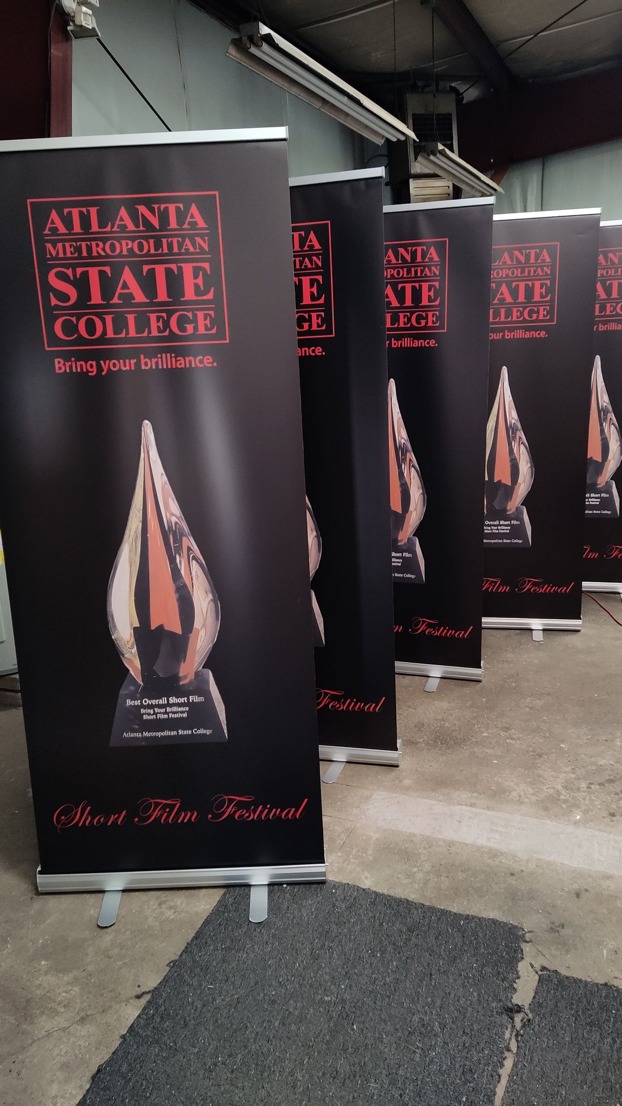 A row of atlanta state college banners are lined up in a room.