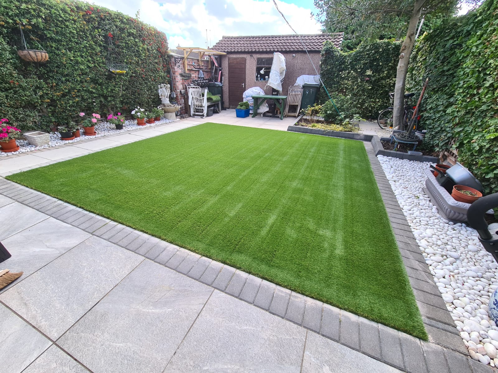 DNA Landscapes Coventry - garden with artificial grass lawn surrounded by paving