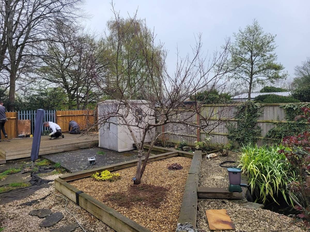 DNA Landscapes about to provide landscaping services for a customer in Wyken Coventry gardeners Coventry laying edging between the lawn and flower beds