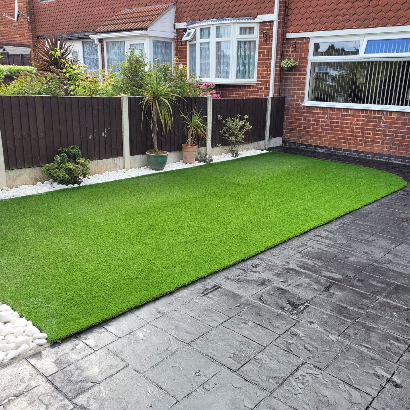 landscaping in Warwick showing new artificial grass and patterned concrete paving