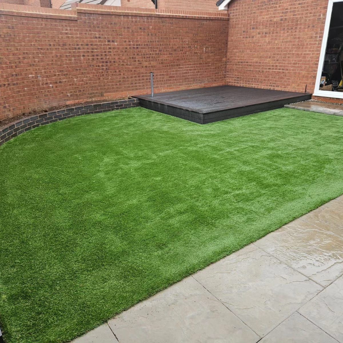 DNA Landscapes Coventry garden with artificial grass lawn surrounded by paving