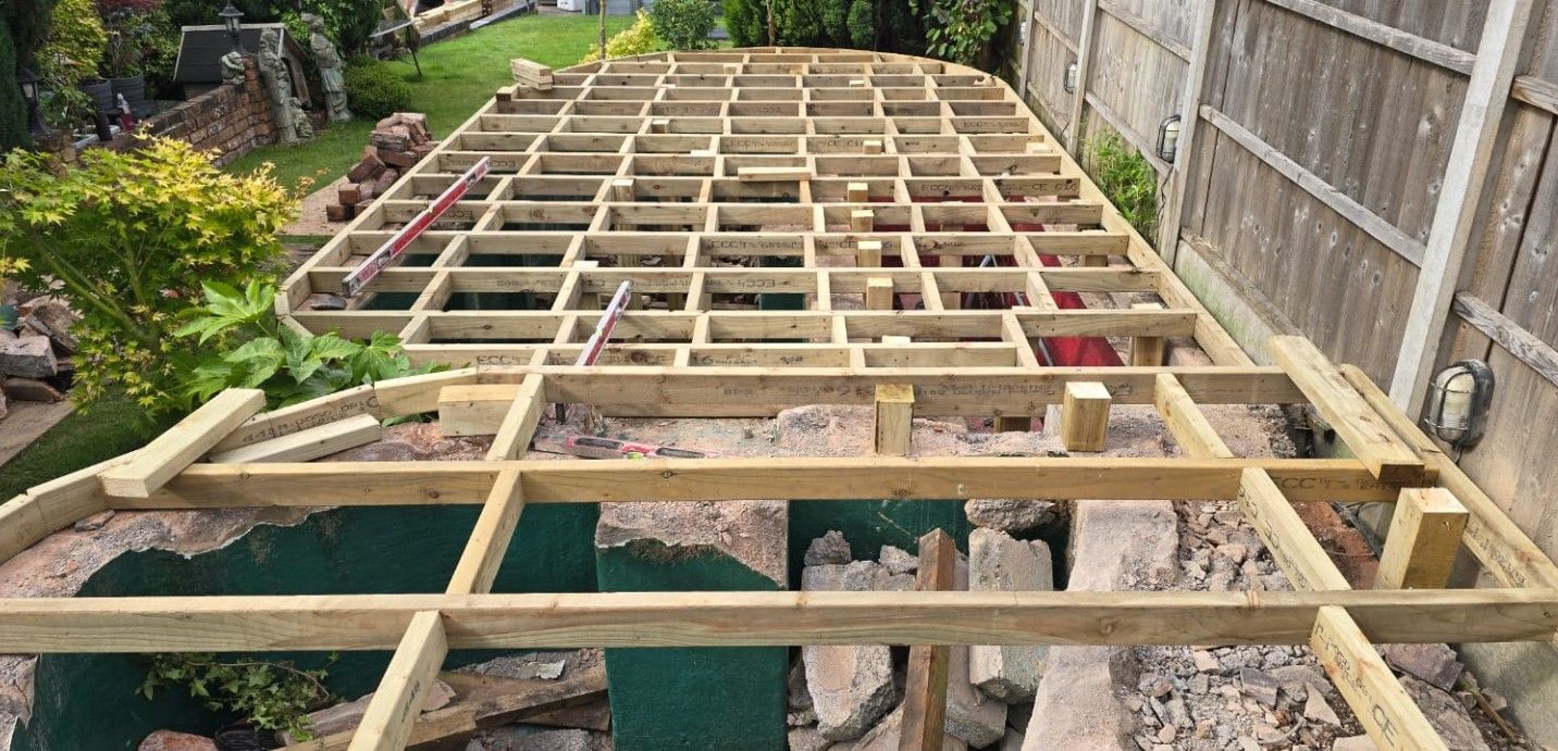 Preparatory landscaping work building the decking frame over the existing pond in Galley Common