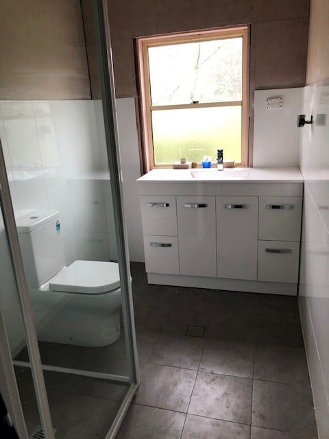 A Bathroom with A Toilet, Sink, and Shower — Alcando Renovations & Maintenance In Forster, NSW