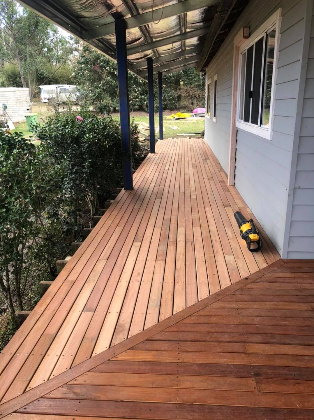 A Wooden Deck with A Covered Walkway Leading to A House — Alcando Renovations & Maintenance In Taree, NSW