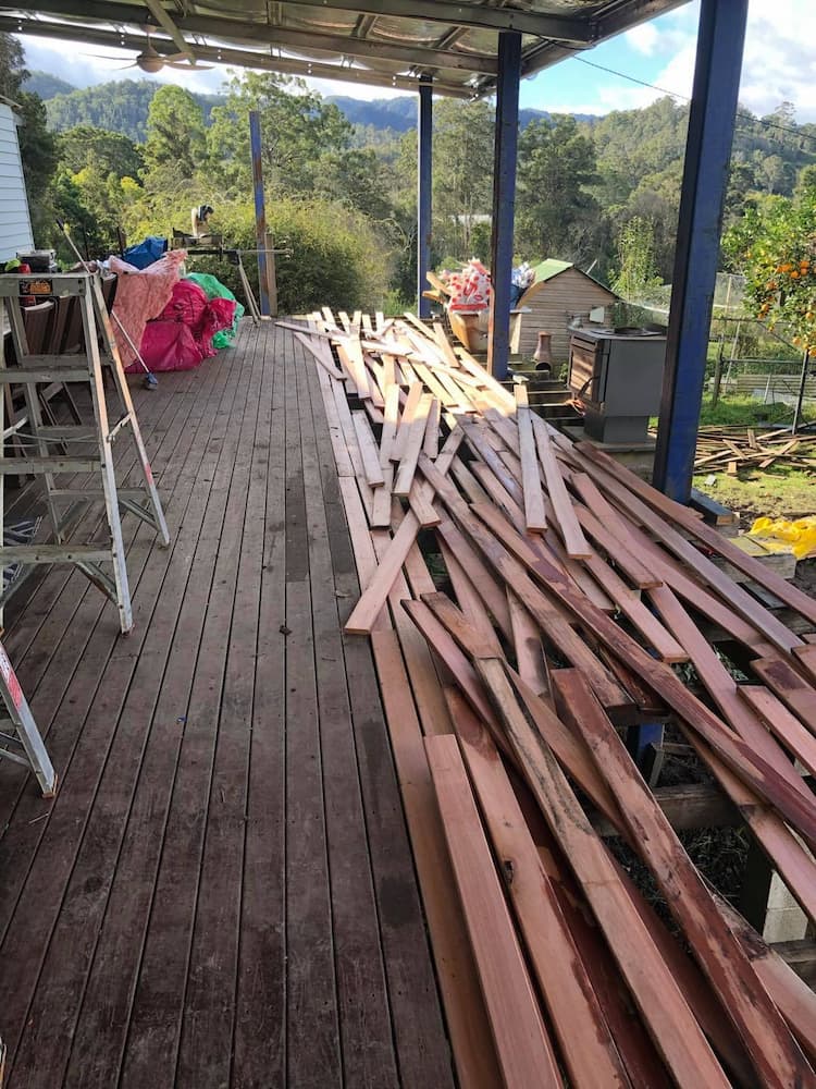 A Pile of Wood Is Sitting on Top of A Wooden Deck — Alcando Renovations & Maintenance In Taree, NSW