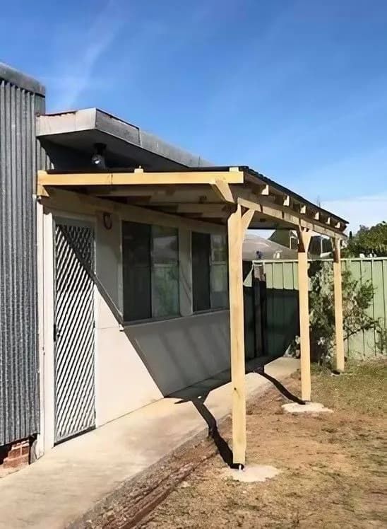 A Wooden Pergola Is Attached to The Side of A Building — Alcando Renovations & Maintenance In Taree, NSW
