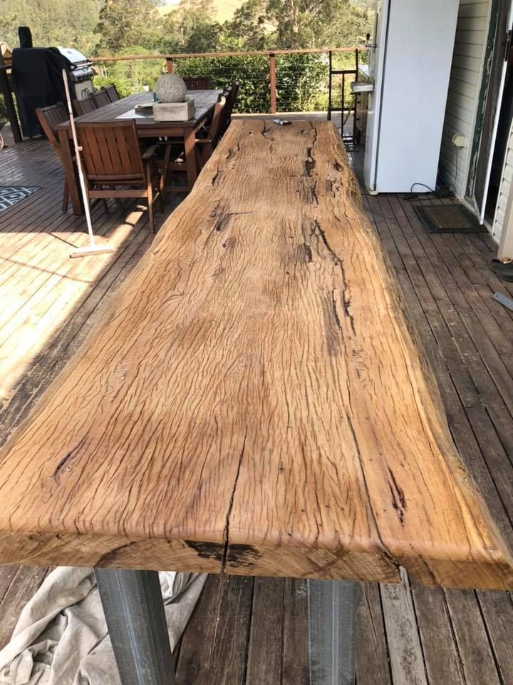 A Long Wooden Table Is Sitting on Top of A Wooden Deck — Alcando Renovations & Maintenance In Old Bar, NSW