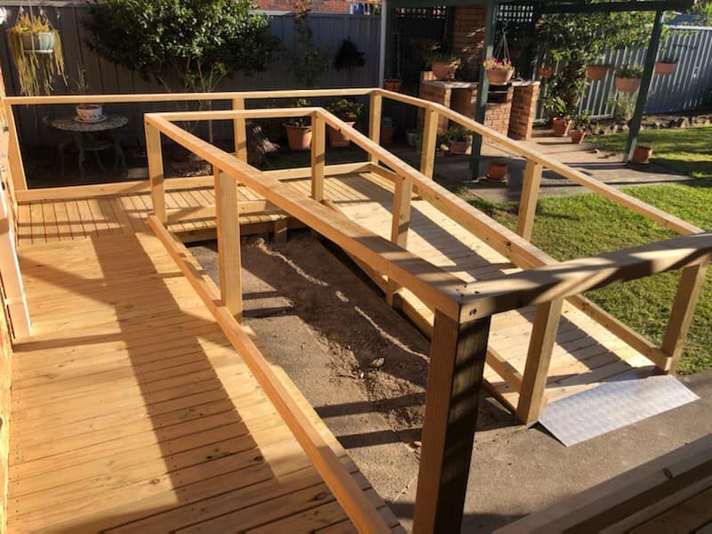 A Wheelchair Is Sitting in A Bathroom Next to A Bathtub — Alcando Renovations & Maintenance In Wingham, NSW