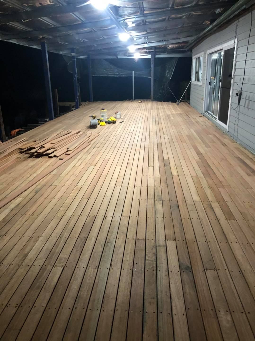 A Large Wooden Deck Is Being Built in The Backyard of A House — Alcando Renovations & Maintenance In Old Bar, NSW